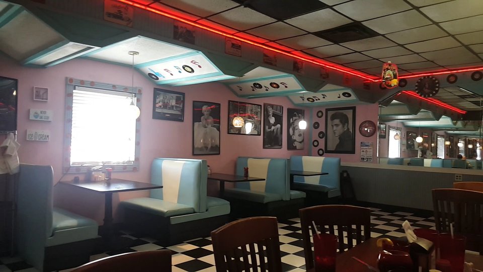 Counter seating with chrome stools and bright lighting.