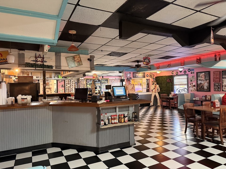 Classic diner booths and framed wall decor.